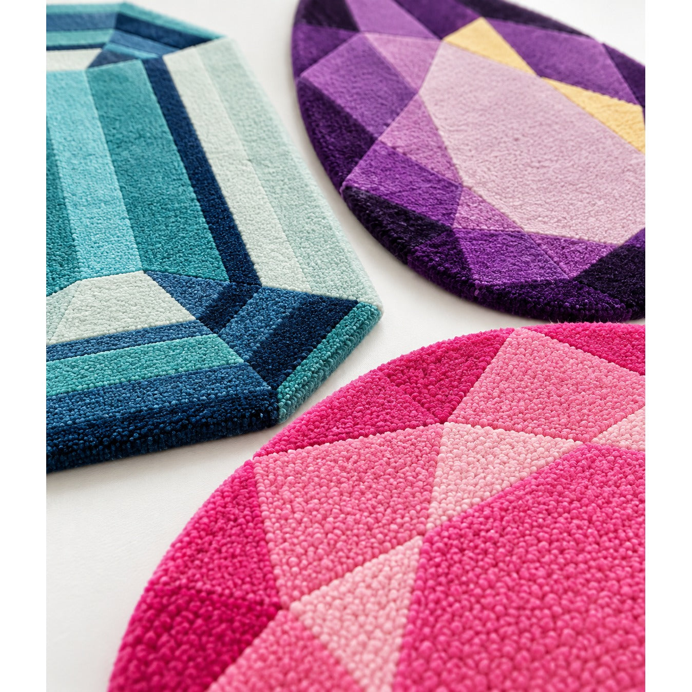 Gem Cluster Rug Set of three mini gem rugs overlapped on the floor of a light living room