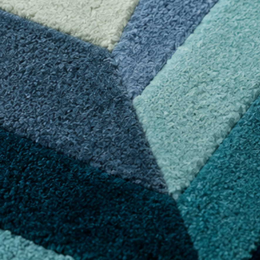 Close-up of the teal facets and one-inch wool pile on the It's Hard To Be Rich Custom Emerald Gem Rug