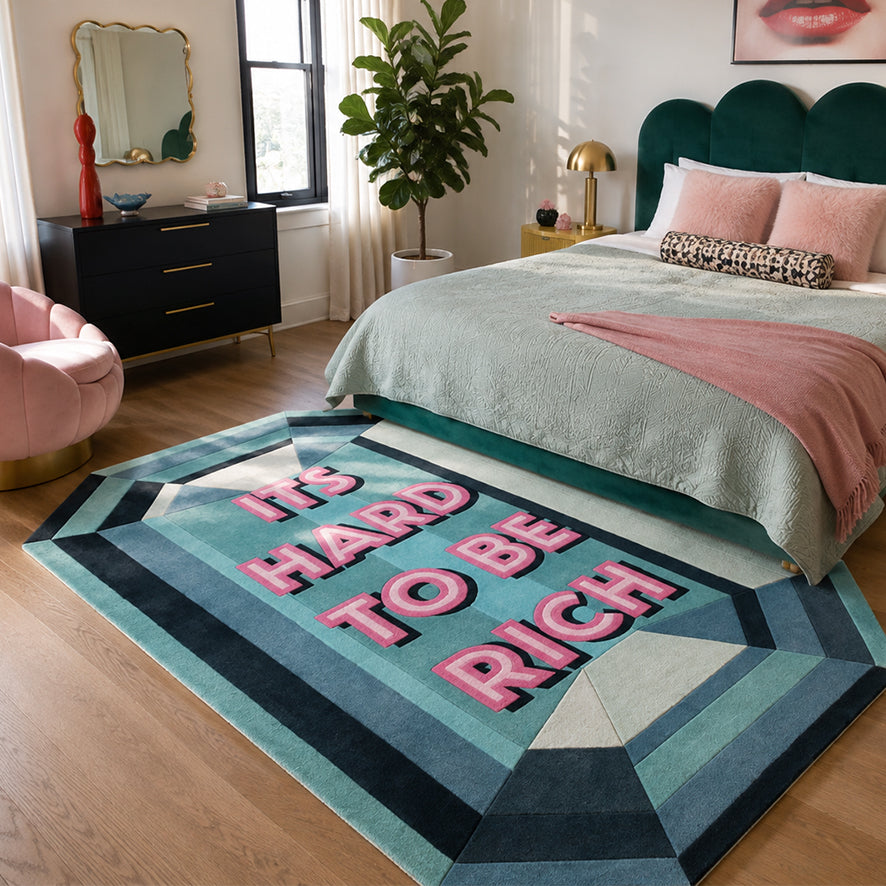 It's Hard To Be Rich Custom Emerald Gem Rug styled at the foot of a bed in a pink and green bedroom