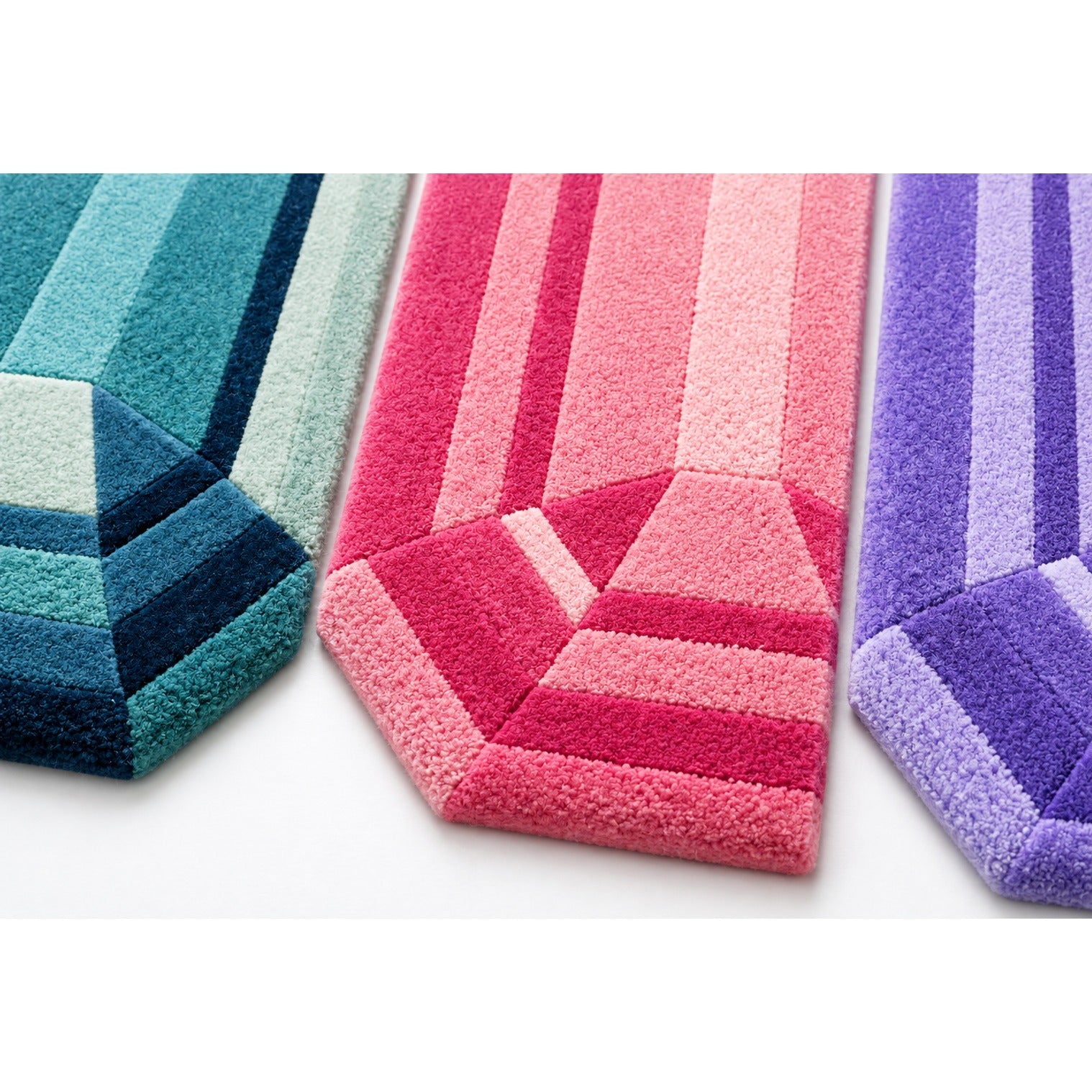 Close-up of the carved facets on the three mini emerald gem rugs in the Mini Gem Emerald Rug Bundle