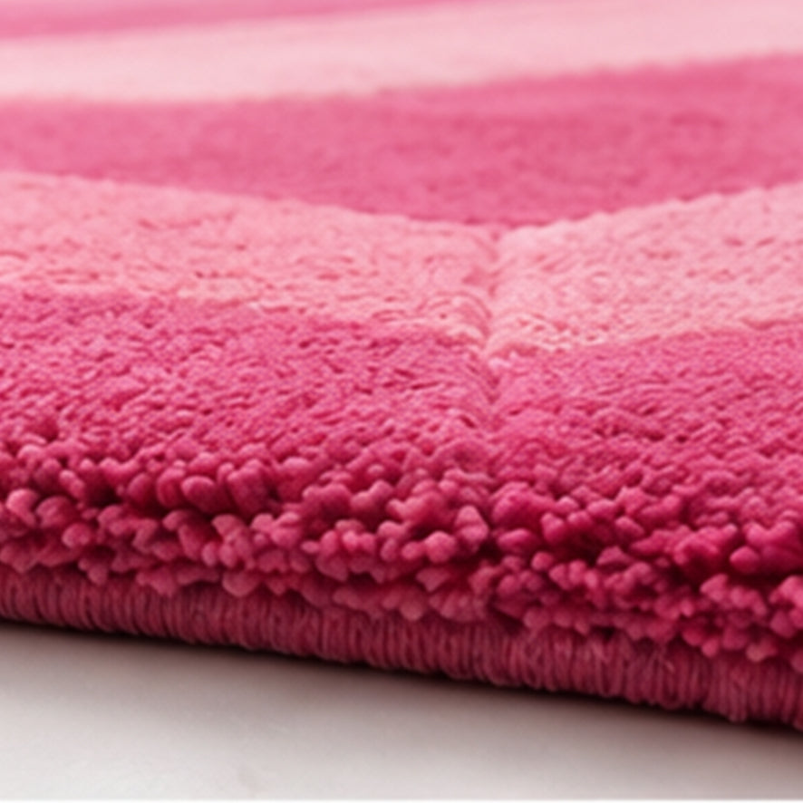 Close-up of the pink wool pile and carved edge on the Rose Quartz Emerald Gem Rug