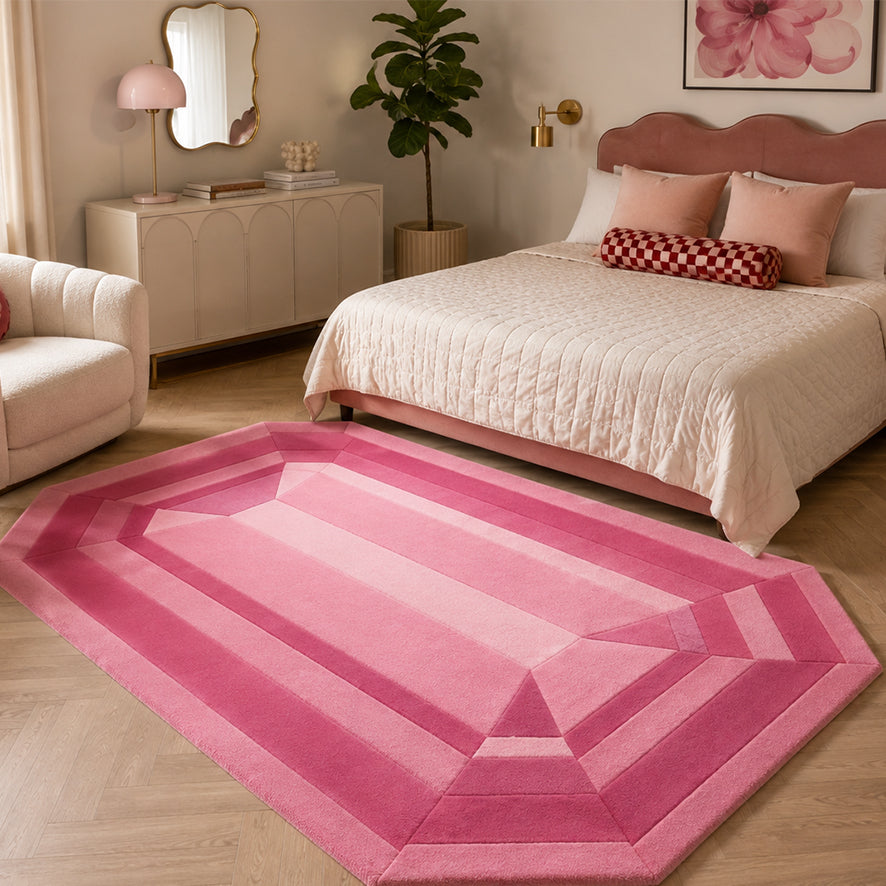 Rose Quartz Emerald Gem Rug styled at the foot of a bed in a pink bedroom