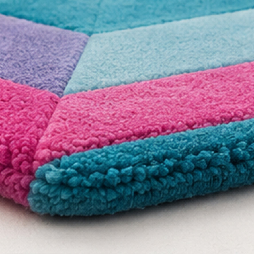 Close-up of the teal and pink wool pile and carved edge on the Sydney Emerald Gem Rug