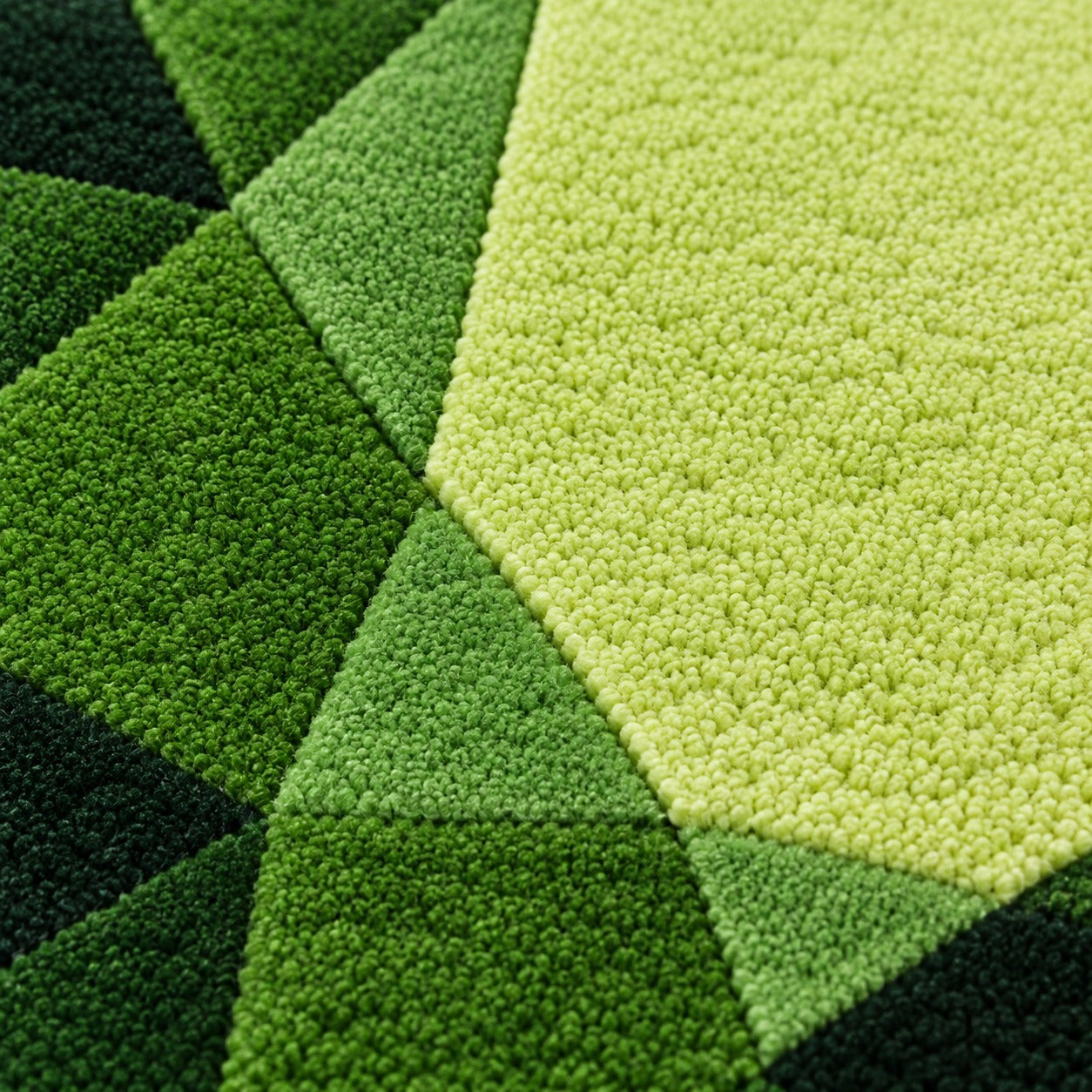 Close-up of the facets on the Tsavorite Garnet Drop Gem Rug running from forest green to a bright lime flash